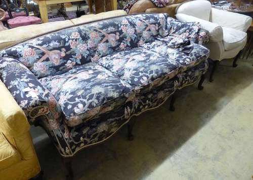 A late 19th century Continental mahogany scroll arm sofa and...