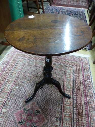 A George III circular oak tripod wine table, Diam.50cm H.71c...