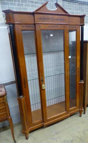 A Biedermeier style ebony inlaid mahogany breakfront display...