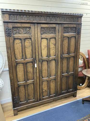 An 18th century style panelled oak triple wardrobe. W-154, D...