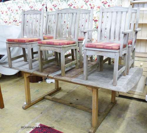 A weathered rectangular teak extending garden table, 220cm e...