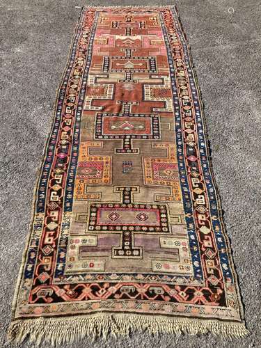 An early 20th century Caucasian Kazak hall carpet, 370 x 128...