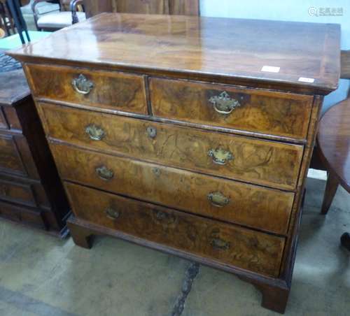 An 18th century crossbanded walnut chest of two short and th...