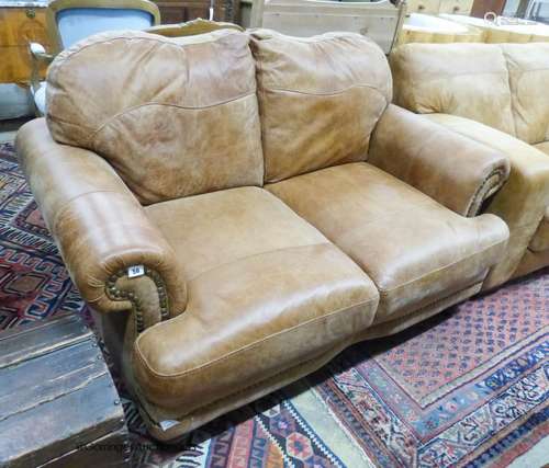 A contemporary small tanned leather two seater sofa, length ...