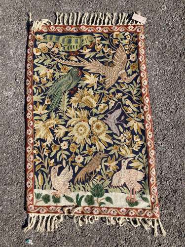 An Indian embroidered wall hanging panel, decorated with bir...