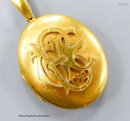 A Victorian yellow metal oval pendant locket with applied mo...