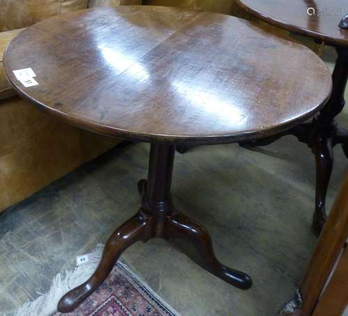 A George III circular mahogany tilt top tripod tea table, Di...