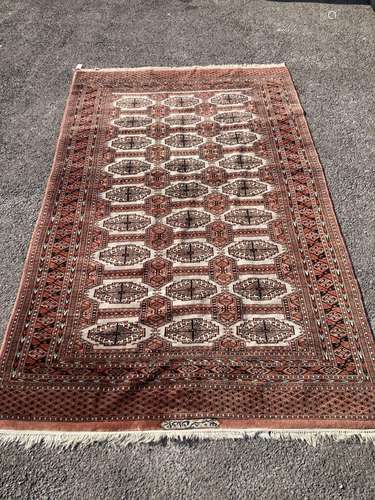 A pale red ground Tekke rug with signed border, 260 x 162cm