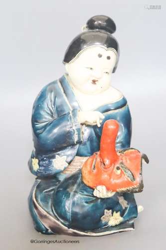 A 19th century Japanese Kutani pottery figure of an actress,...