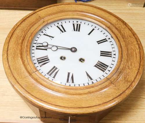 An Edwardian pale oak wall clock, with key and pendulum, dia...