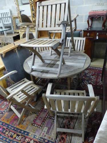 A circular weathered teak extending garden table, 180cm exte...