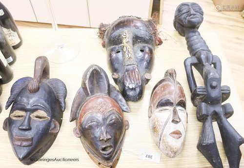 Tribal carvings including carved tribal masks and a figure, ...