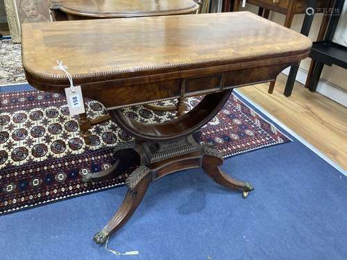 A regency rosewood banded mahogany folding card table. W-90,...