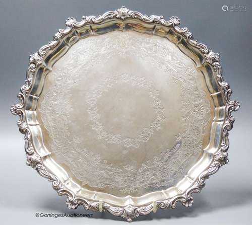 An Edwardian engraved shaped circular silver salver, with sc...