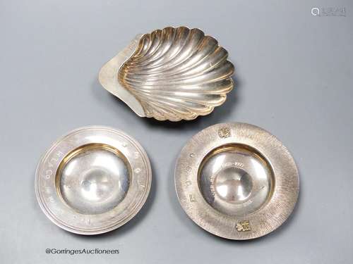 Two small silver commemorative dishes and a silver butter sh...