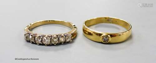 A yellow metal and graduated seven stone diamond set half ho...