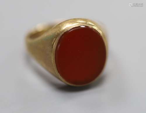 A modern 9ct gold and oval carnelian set signet ring, size N...