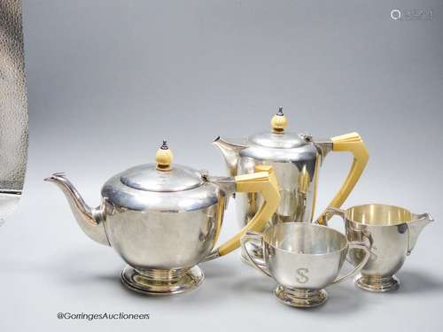 A 1930's Art Deco silver four piece tea set, with ivory hand...