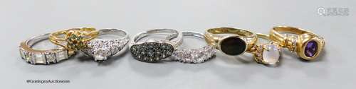 Fourteen assorted modern 14k white or yellow metal and gem s...