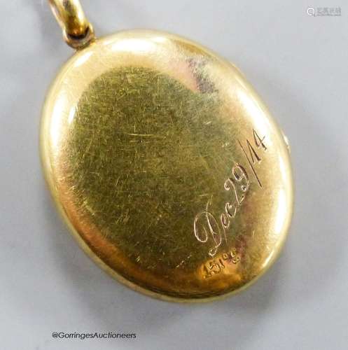 A George V 15ct oval locket, with engraved date, 24mm, gross...