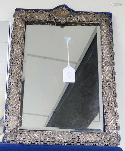 A large Edwardian repousse silver mounted easel mirror with ...