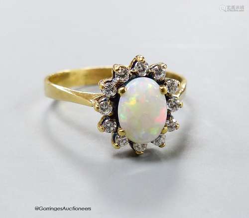 A modern yellow metal, white opal and diamond set oval clust...