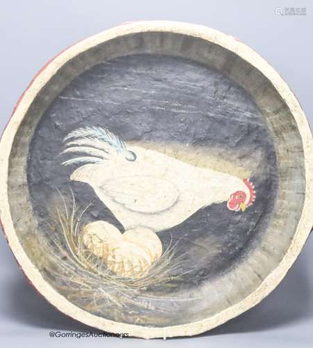 A papier mache dish with a painted interior of a chicken and...