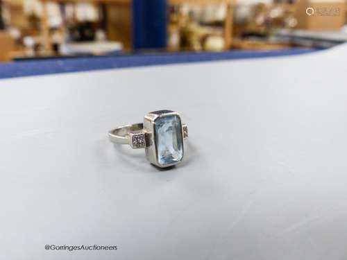 A modern platinum, aquamarine and diamond set three stone dr...