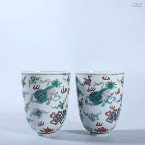 A pair of small cups with colorful animal patterns in the Qi...