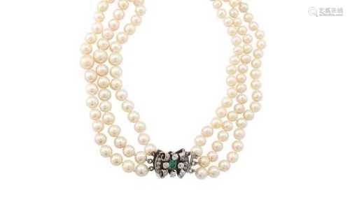 A cultured pearl necklace with an emerald and diamond clasp