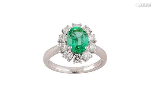 An emerald and diamond cluster ring