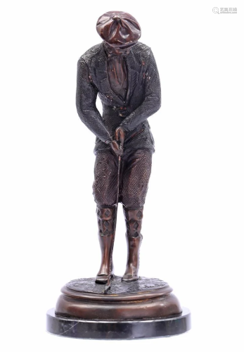 Bronze sculpture of a golfer