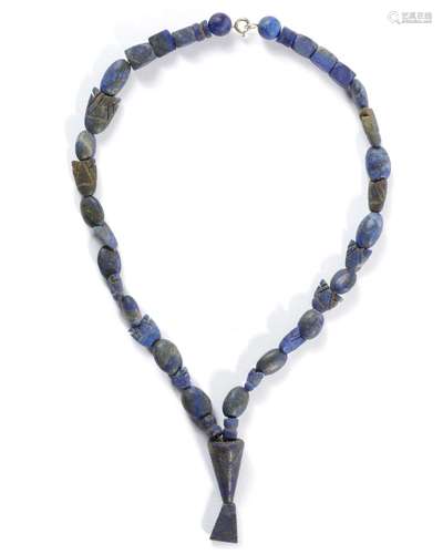 A LAPIS LAZULI BEAD NECKLACE, ANCIENT NEAR EAST, 1ST MILLENI...