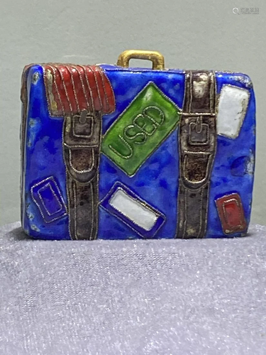 A SMALL ENAMELED SUITCASE