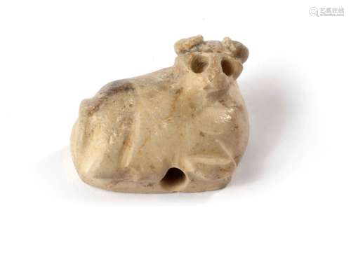 AN ARCADIAN PERIOD SEATED BULL AMULET, 2ND MILLENIUM BC