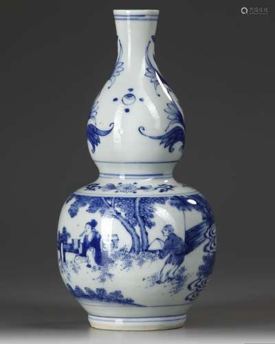 A CHINESE BLUE AND WHITE DOUBLE-GOURD-FORM VASE, QING DYNAST...