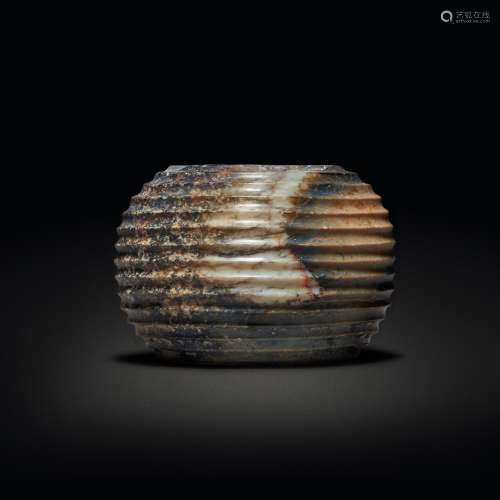 A beige and brown jade ribbed vessel, Zhou dynasty or later ...