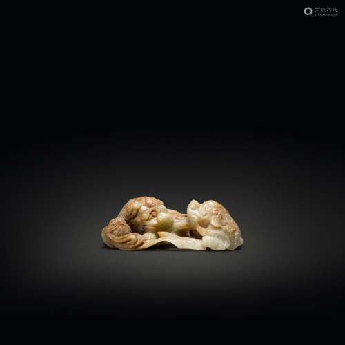 A celadon and russet jade 'Buddhist lion' group, Ming dynast...