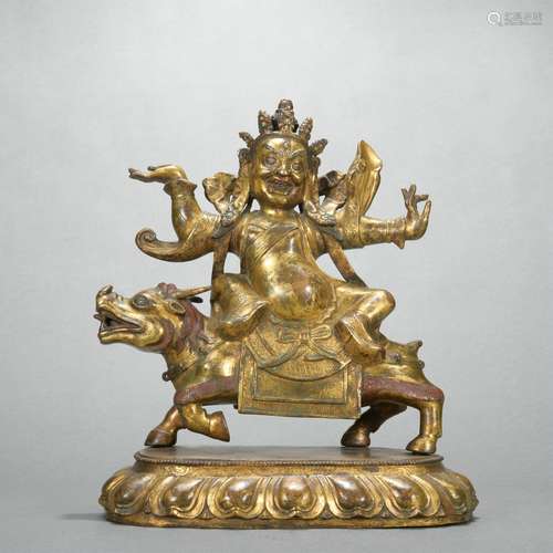 A gilt-bronze statue of Mammon