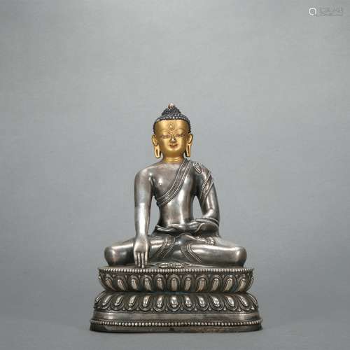 A silver statue of Shakya Muni