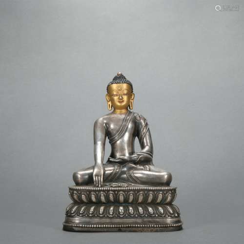 A silver statue of Shakya Muni
