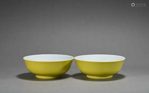 A pair of yellow glazed cup