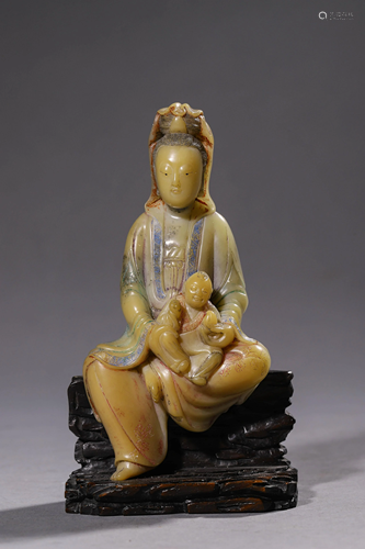 A Carved Soapstone Seated Avalokitesvara Figurine.