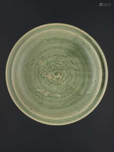 A LONGQUAN CELADON CARVED 'PEONY' DISH, MING