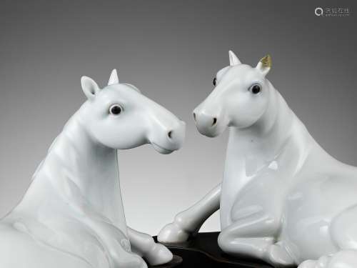 A PAIR OF WHITE-GLAZED FIGURES OF HORSES, QING
