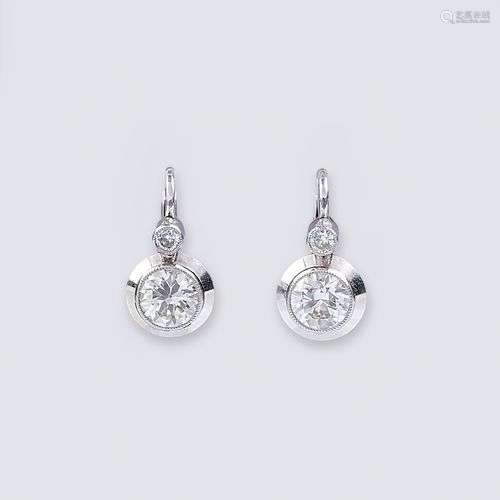 A pair of diamond earrings.