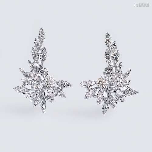 A pair of diamond earrings.