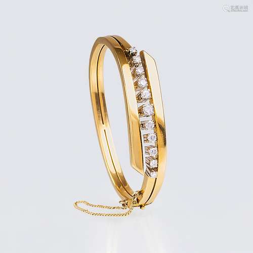 A Gold Bangle Bracelet with Diamonds.