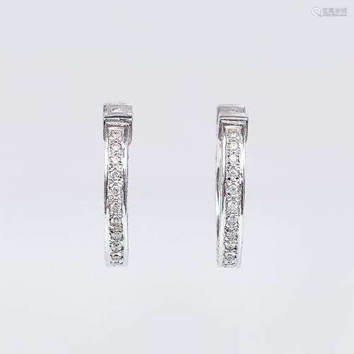 A pair of diamond earrings.