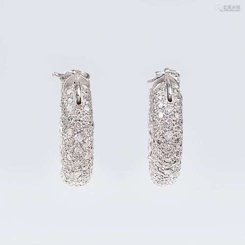 A pair of diamond earrings.